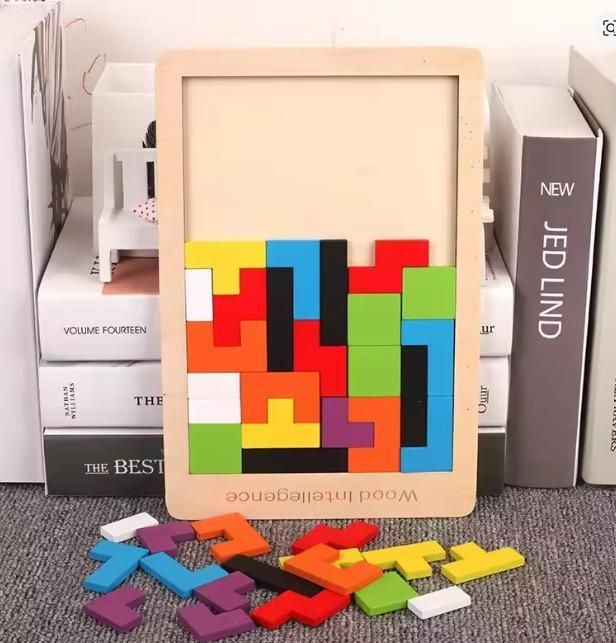 Colorful wooden puzzle with pieces on a bookshelf background